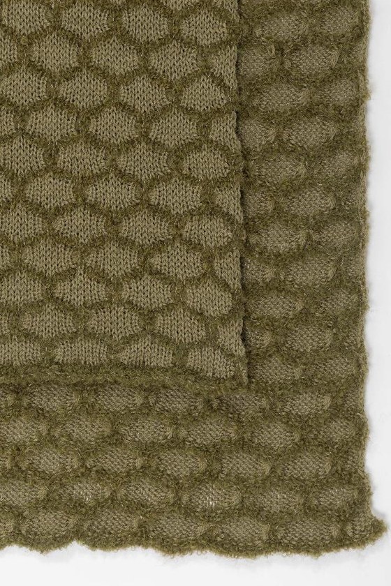 Écharpe olive pliée, gros plan sur la maille en relief